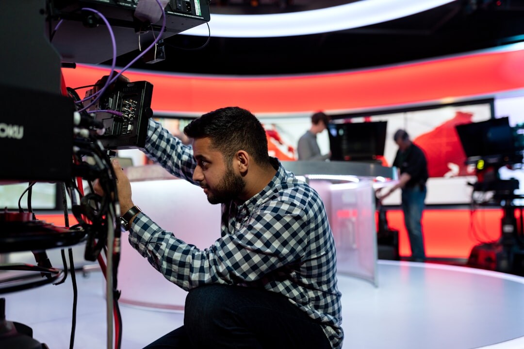 Modern newsroom studio with cameras and anchor desk